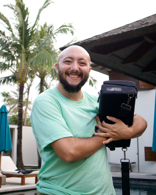 The AcroBack Go in blue on location in Bali, gear used for AcroYoga practice and recovery