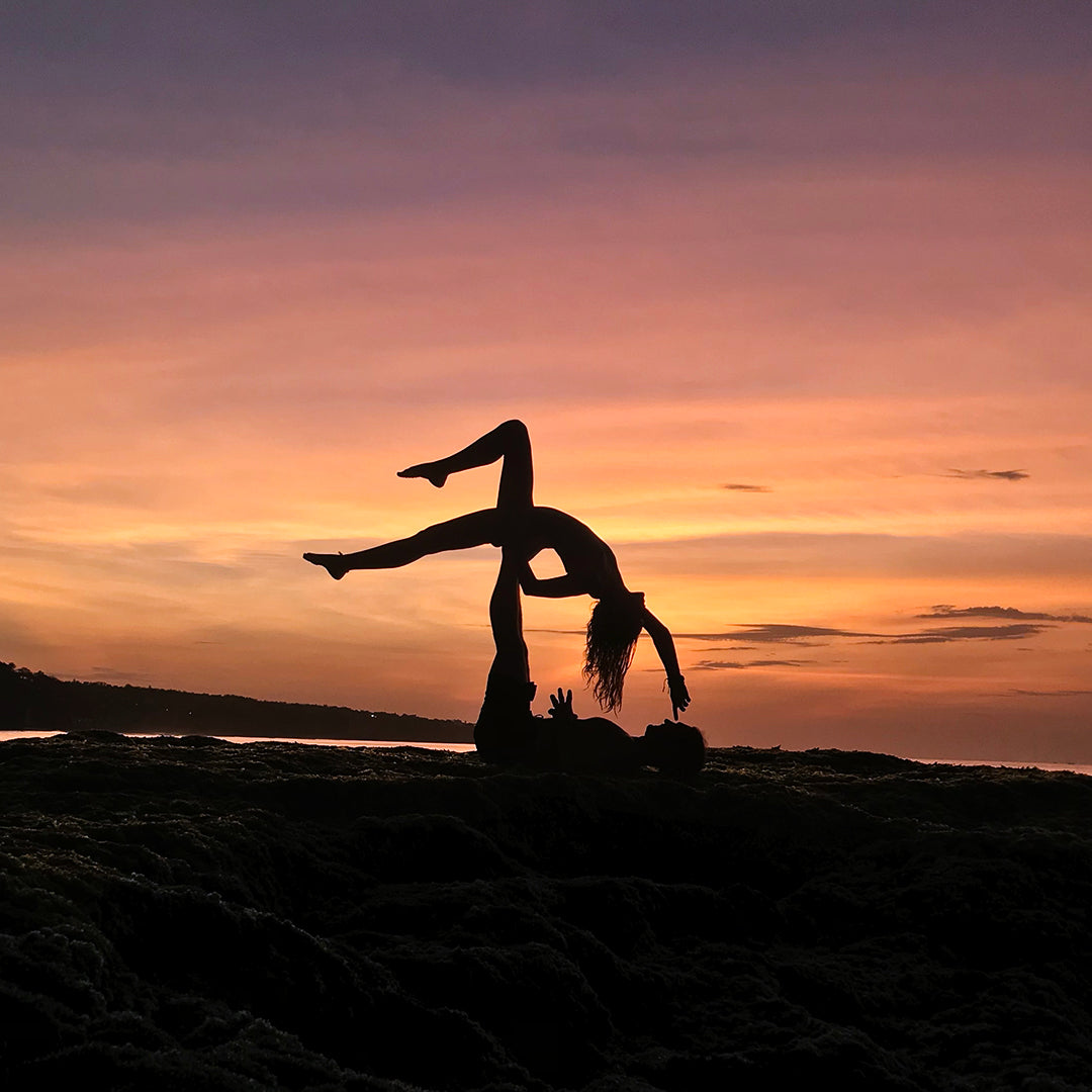 acro yoga pose at sunset silhouette