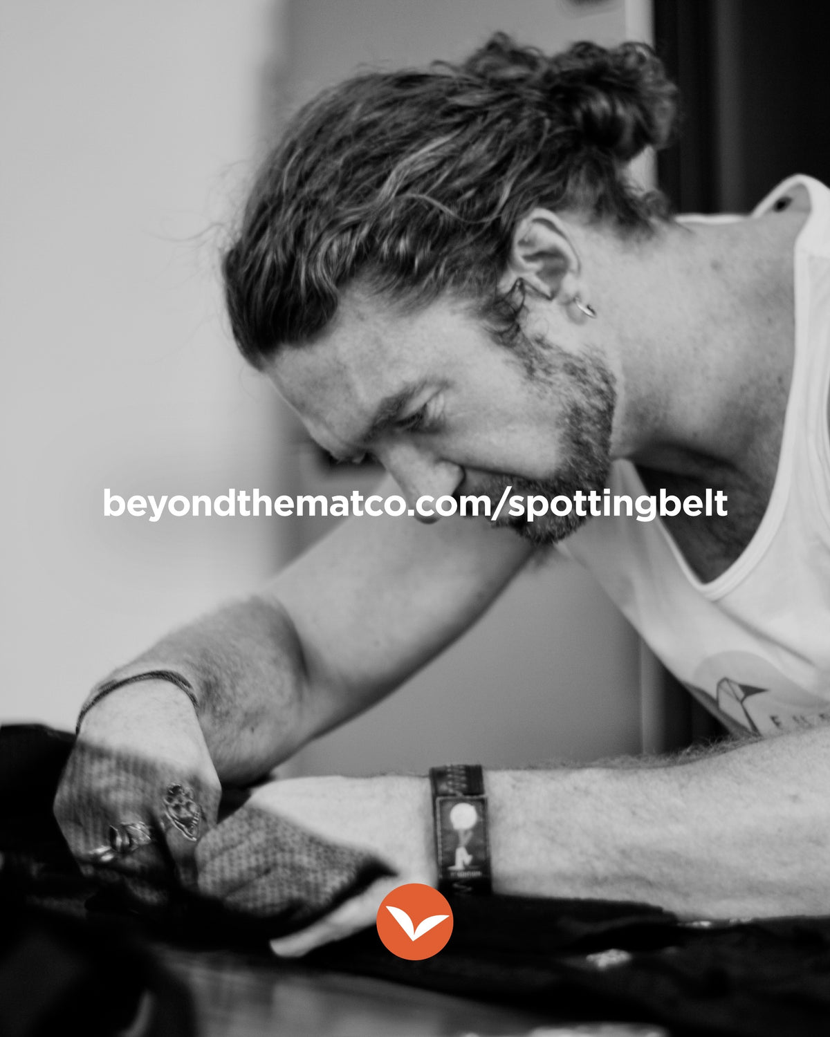 A maker inspecting the construction of a spotting belt