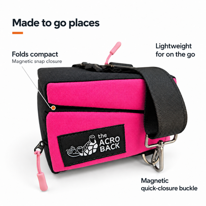 The AcroBack Go in rose pink and black, folded compact, with callouts for magnetic snap closure, magnetic quick-closure buckle and lightweight travel.