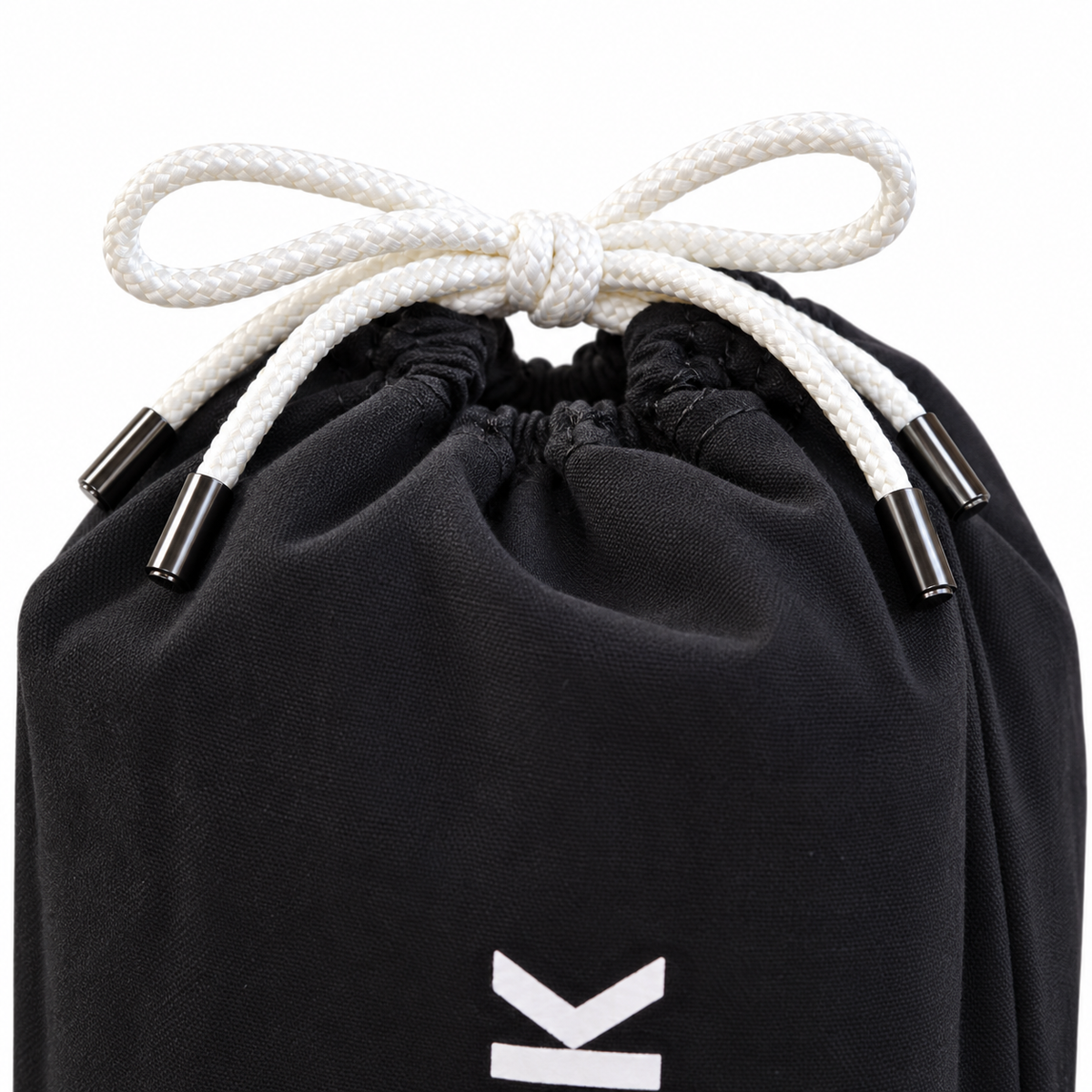 Close-up of the AcroBack Travel Bag white drawstring closure with metal cord tips.