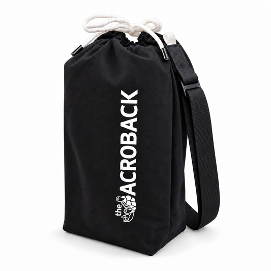 Black AcroBack Travel Bag with white AcroBack logo, drawstring closure and adjustable shoulder strap, on a white background.