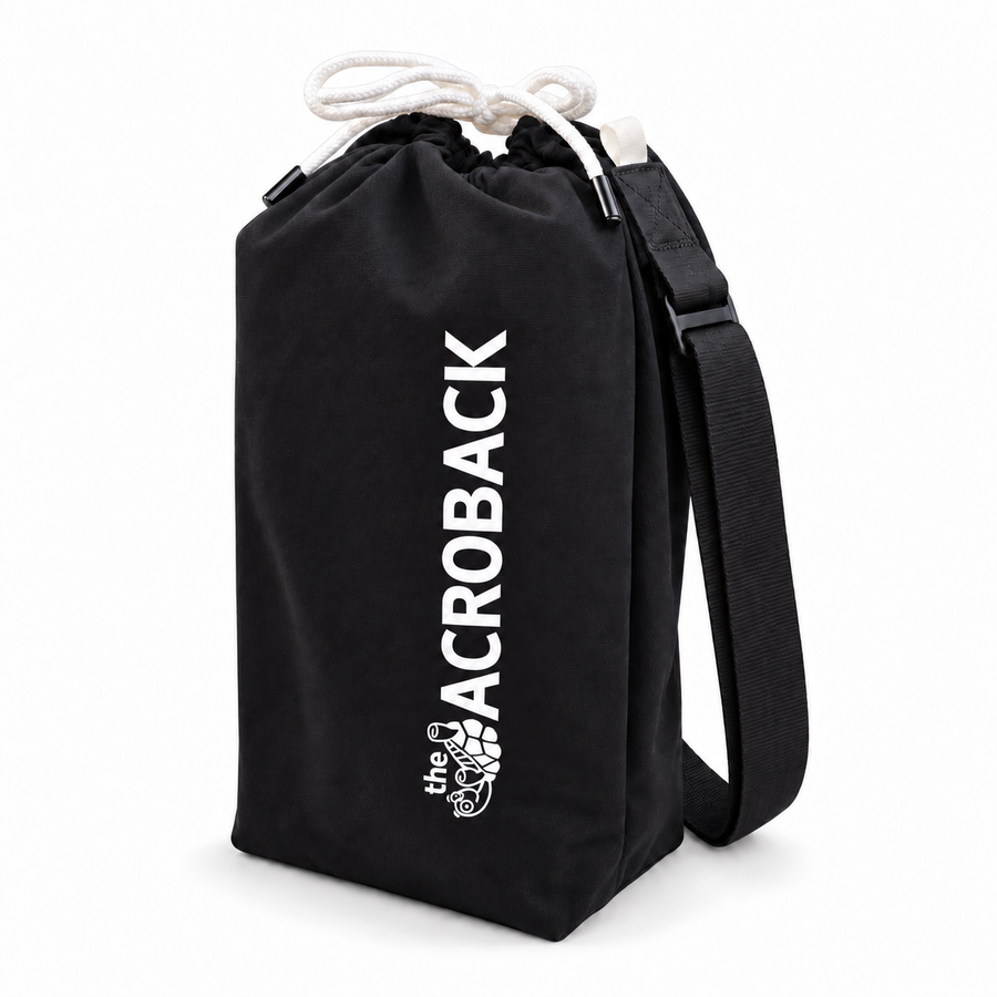 Black AcroBack Travel Bag with white AcroBack logo, drawstring closure and adjustable shoulder strap, on a white background.