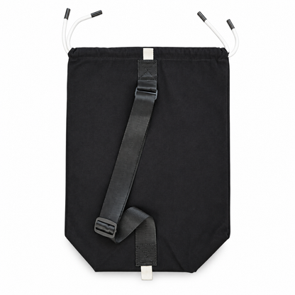 Rear view of the black AcroBack Travel Bag showing the adjustable shoulder strap and white attachment loops.