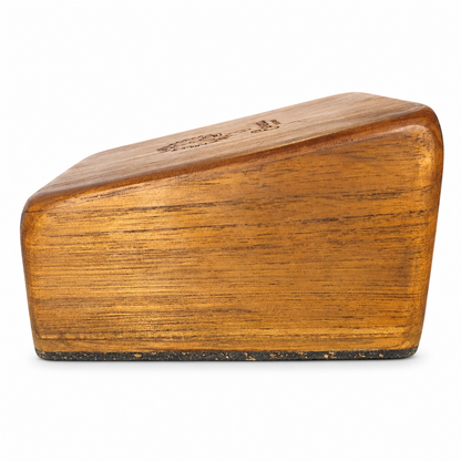 Side profile of an angled Elemental teak handstand block showing its sloped surface and cork base on white.